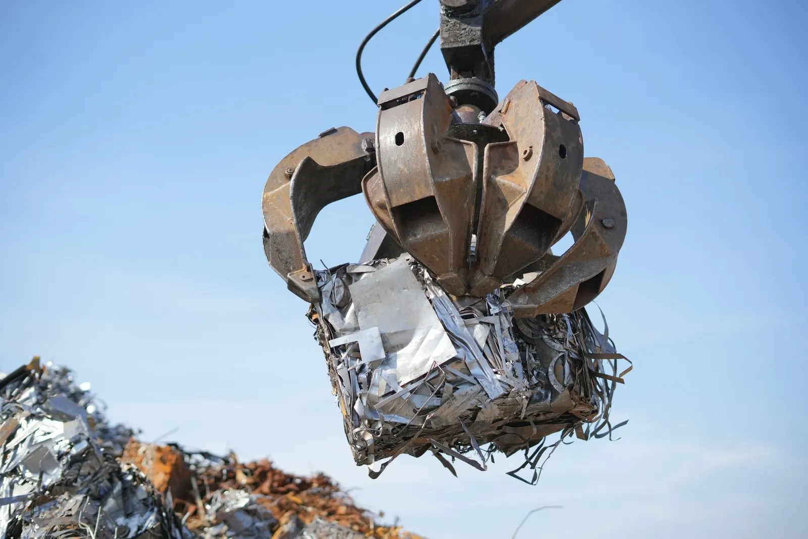 Grab lifting a crushed bale of scrap metal