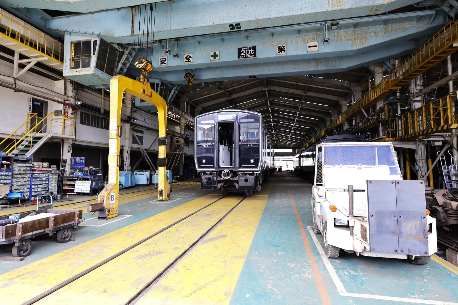 Commuter train on a service track inside a rail maintenance depot